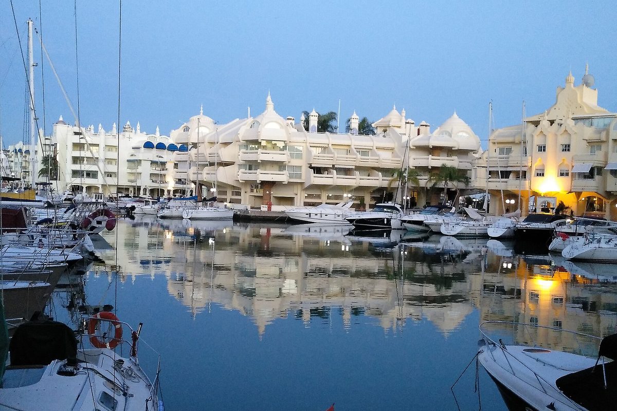 Puerto Marina's white buildings reflected in the water