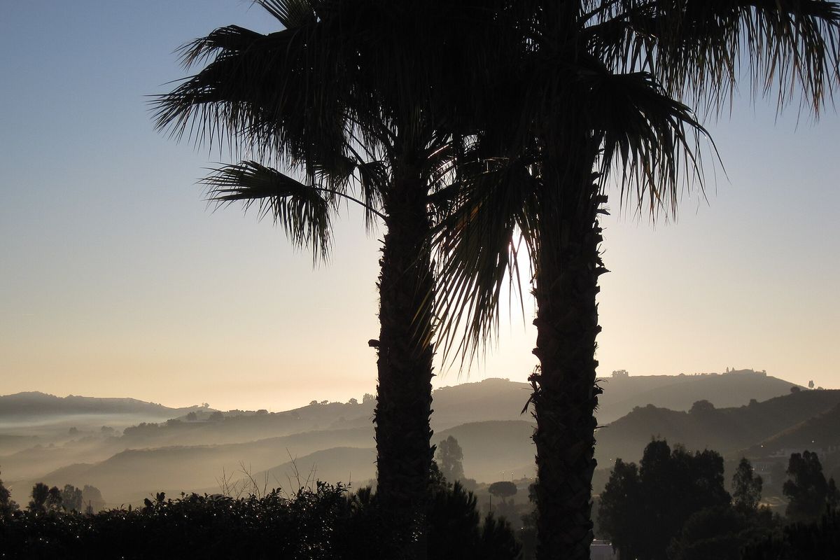 Sunrise over the misty hills behind La Cala