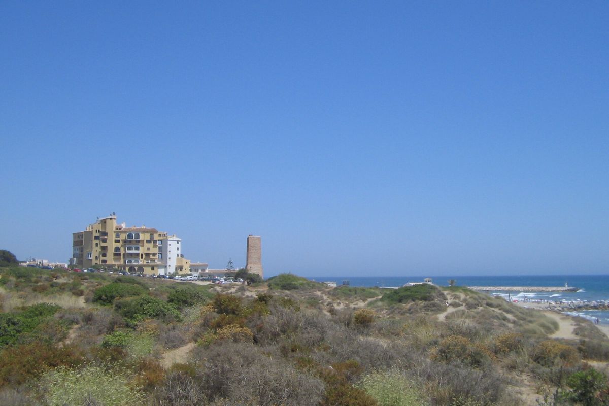 The dunes at Artola, with the watchtower and the sea behind