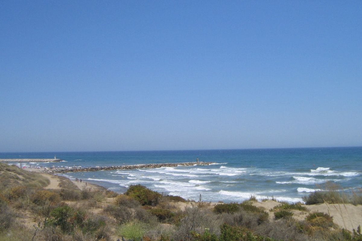 The dunes running down to the sea and the Cabopino breakwater