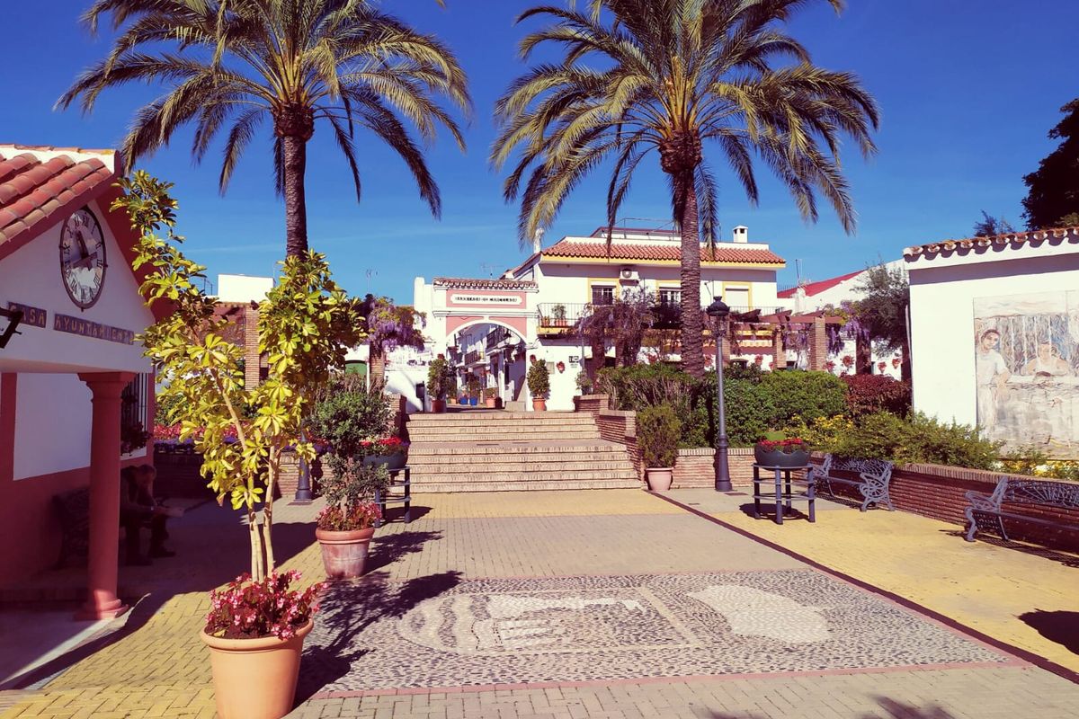 The square in Cancelada, with palms and white houses