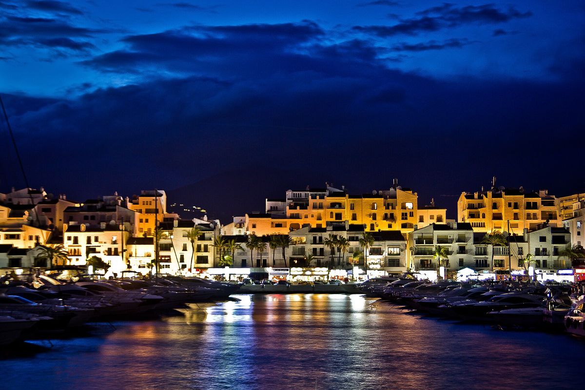 Puerto Banús at night, lit up across the water