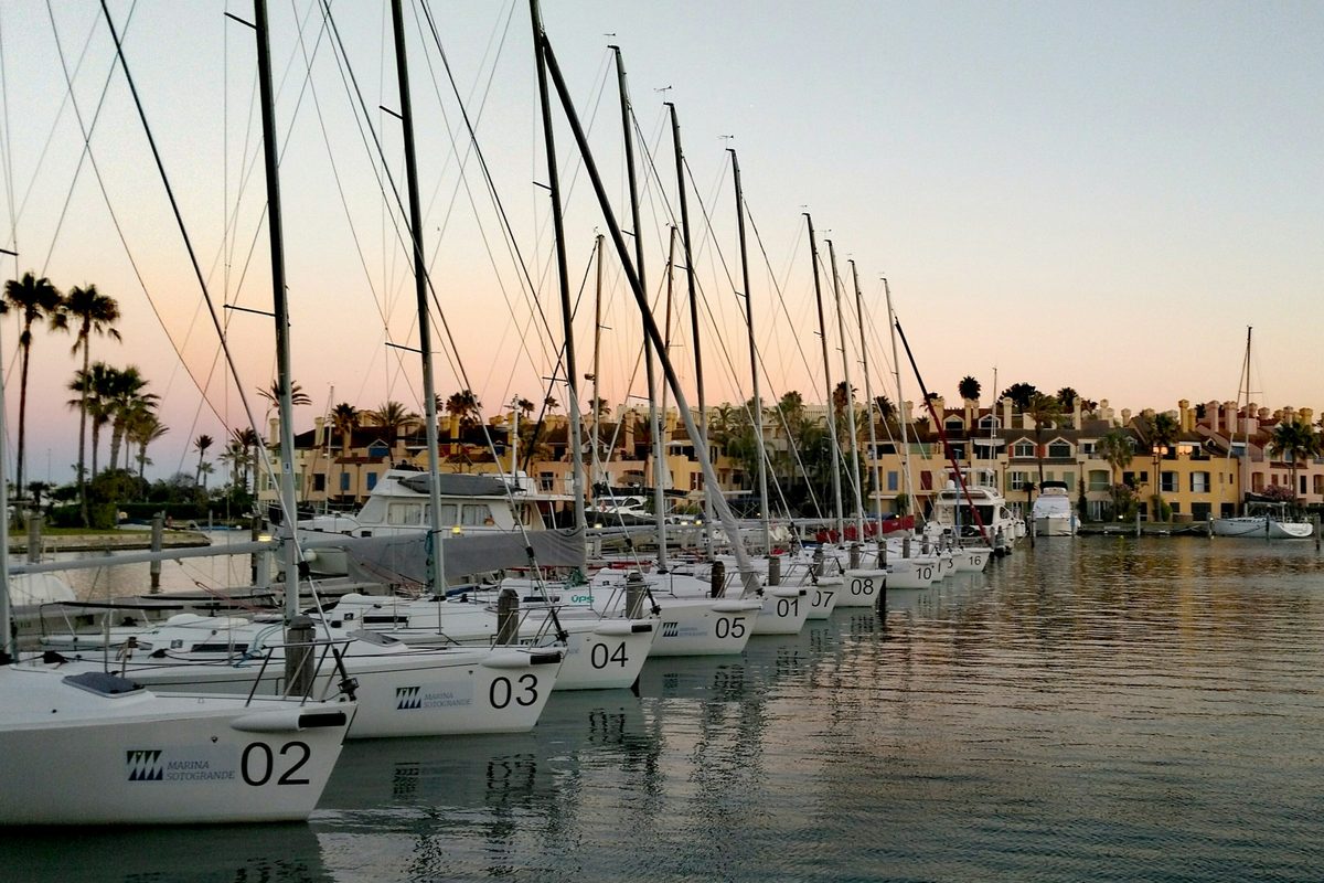 Sailboats moored in the marina at dusk
