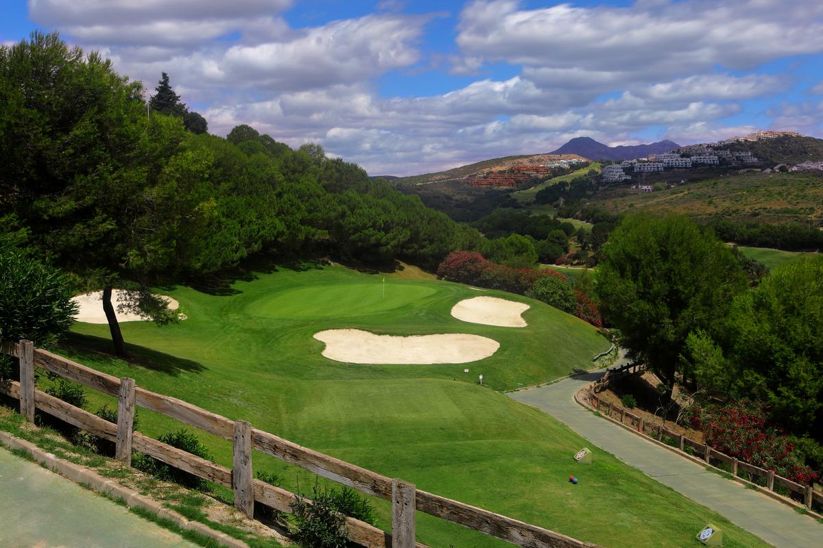 Green and bunkers set into the hillside
